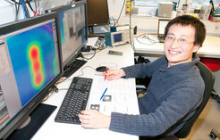 Shichao Yan at the control terminal of the 'scanning tunneling microscope' (STM) showing a chain of 3 iron atoms.