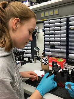 One of the girls steers a laser beam towards a target