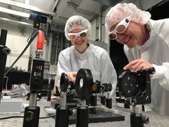 Wiebke Kohlbrecher and Michael Först check her set-up in the laser lab.